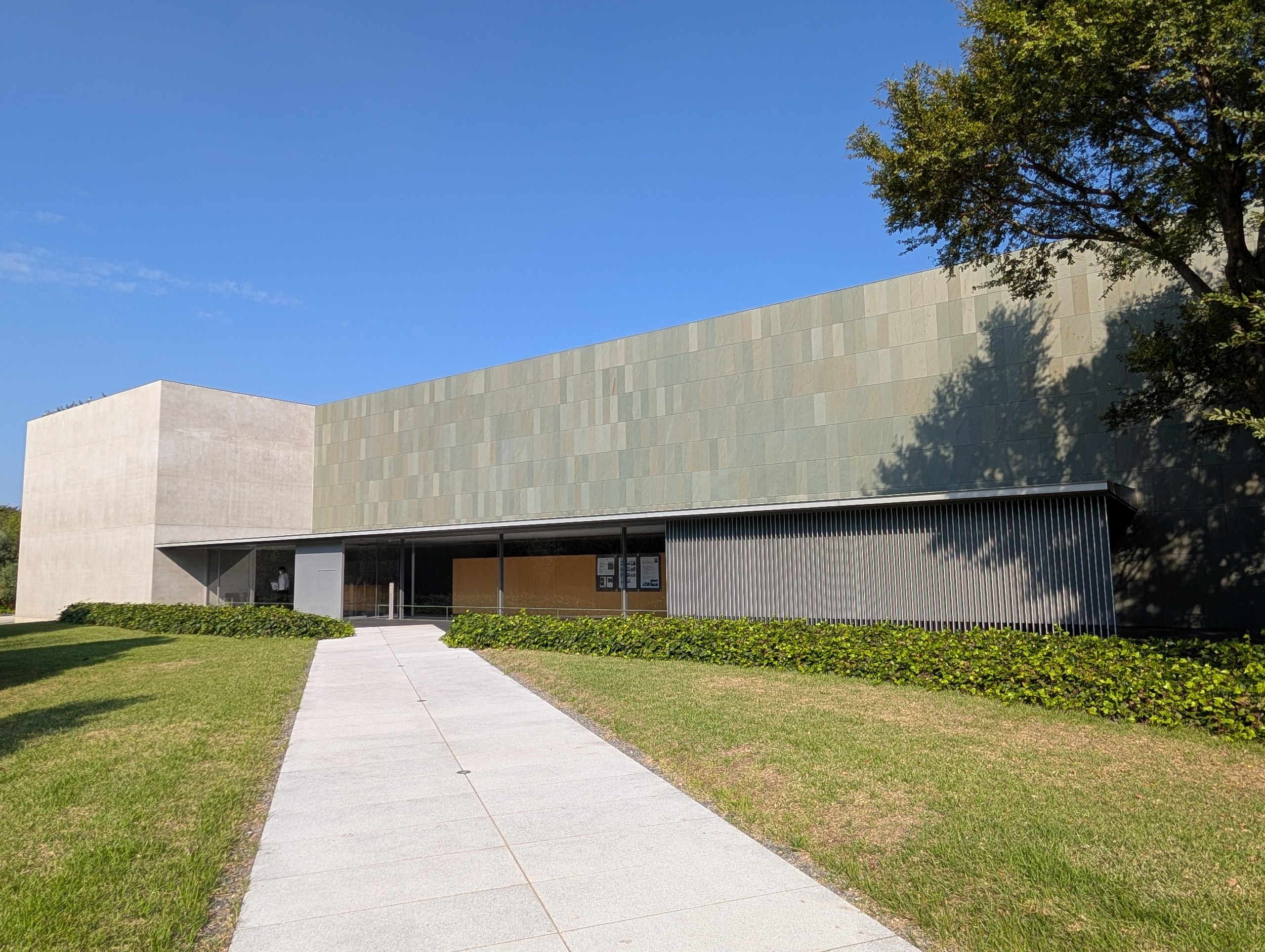 緑がかった石の壁の、すっきりした美術館の建物