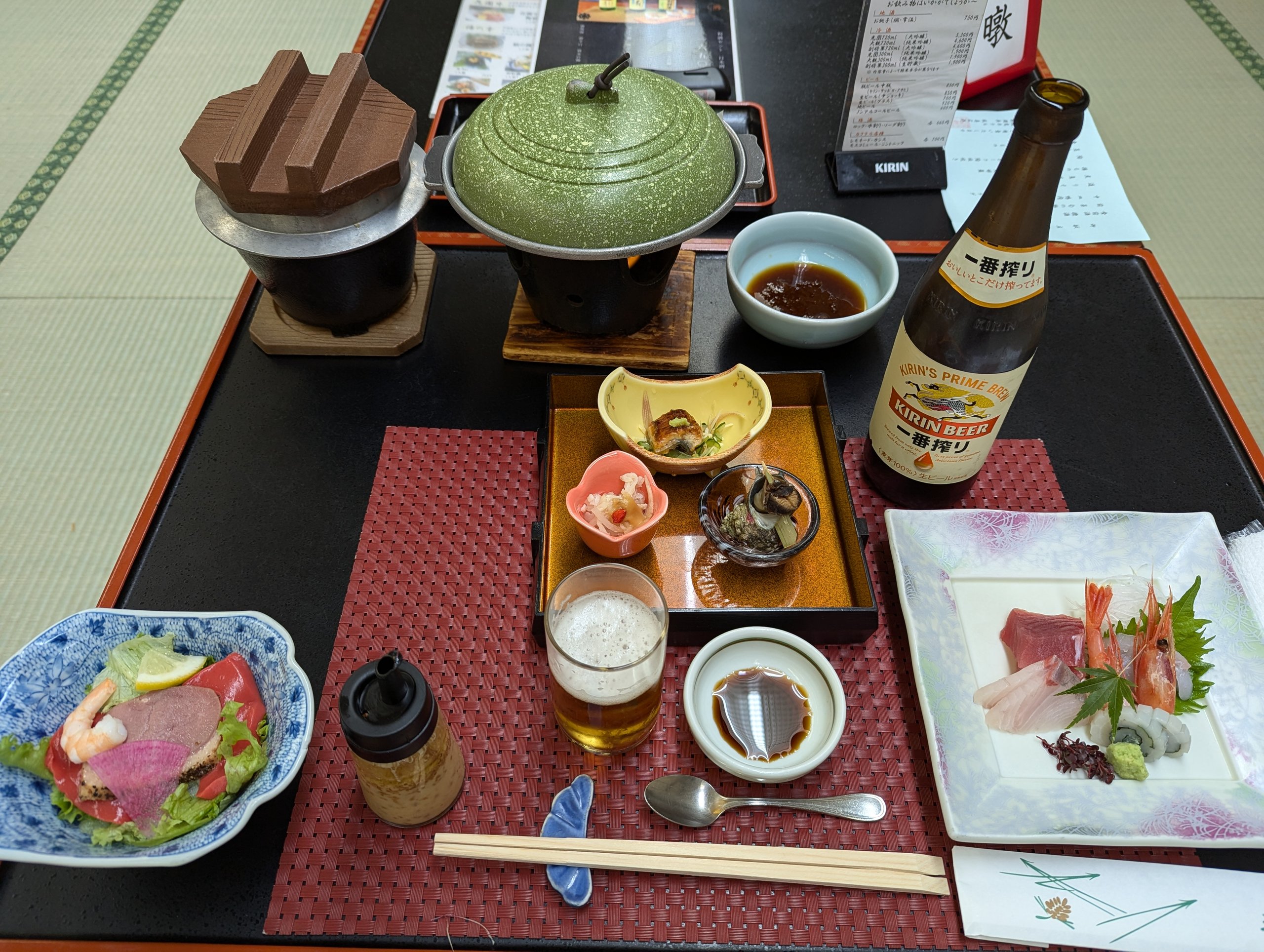 刺身や小鉢、鍋が並ぶ夕食のお膳