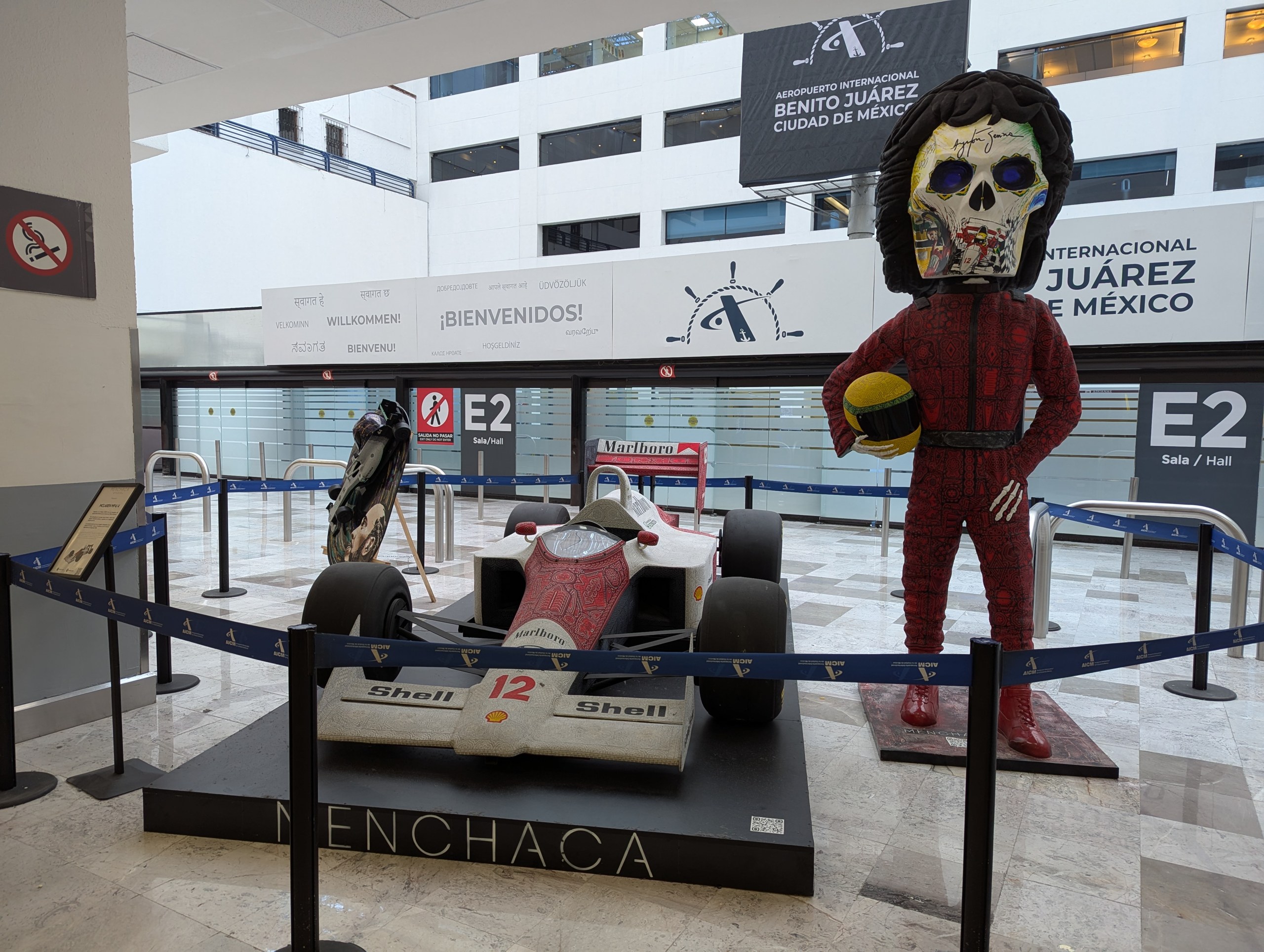 メキシコシティの空港に飾られた、レーシングスーツを着たガイコツの像とF1のマシン