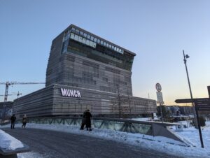 雪の残る広場の先にそびえる、「MUNCH」の文字の入った高層の建物