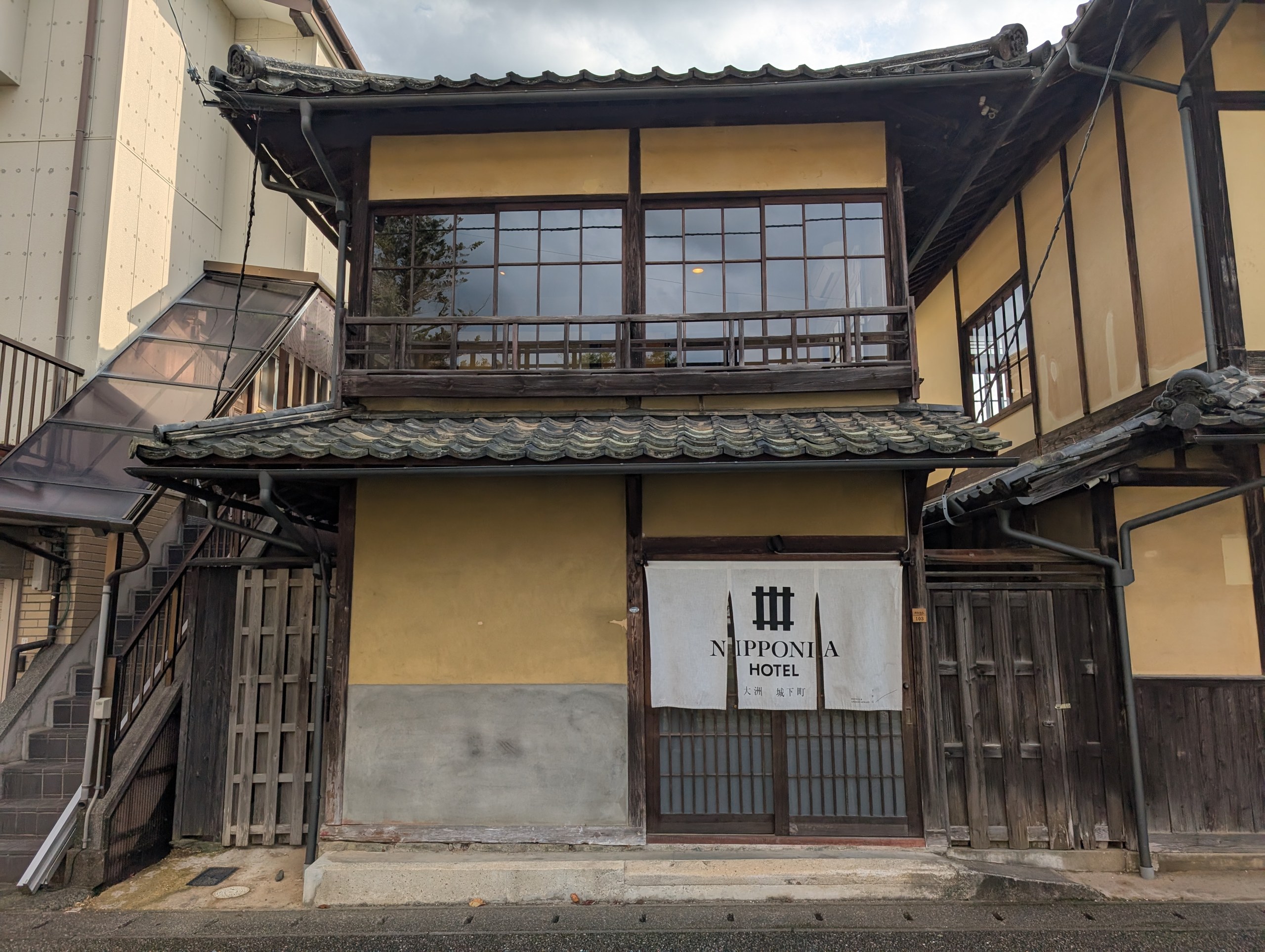 「NIPPONIA HOTEL」の看板が掛かった、古い2階建ての建物