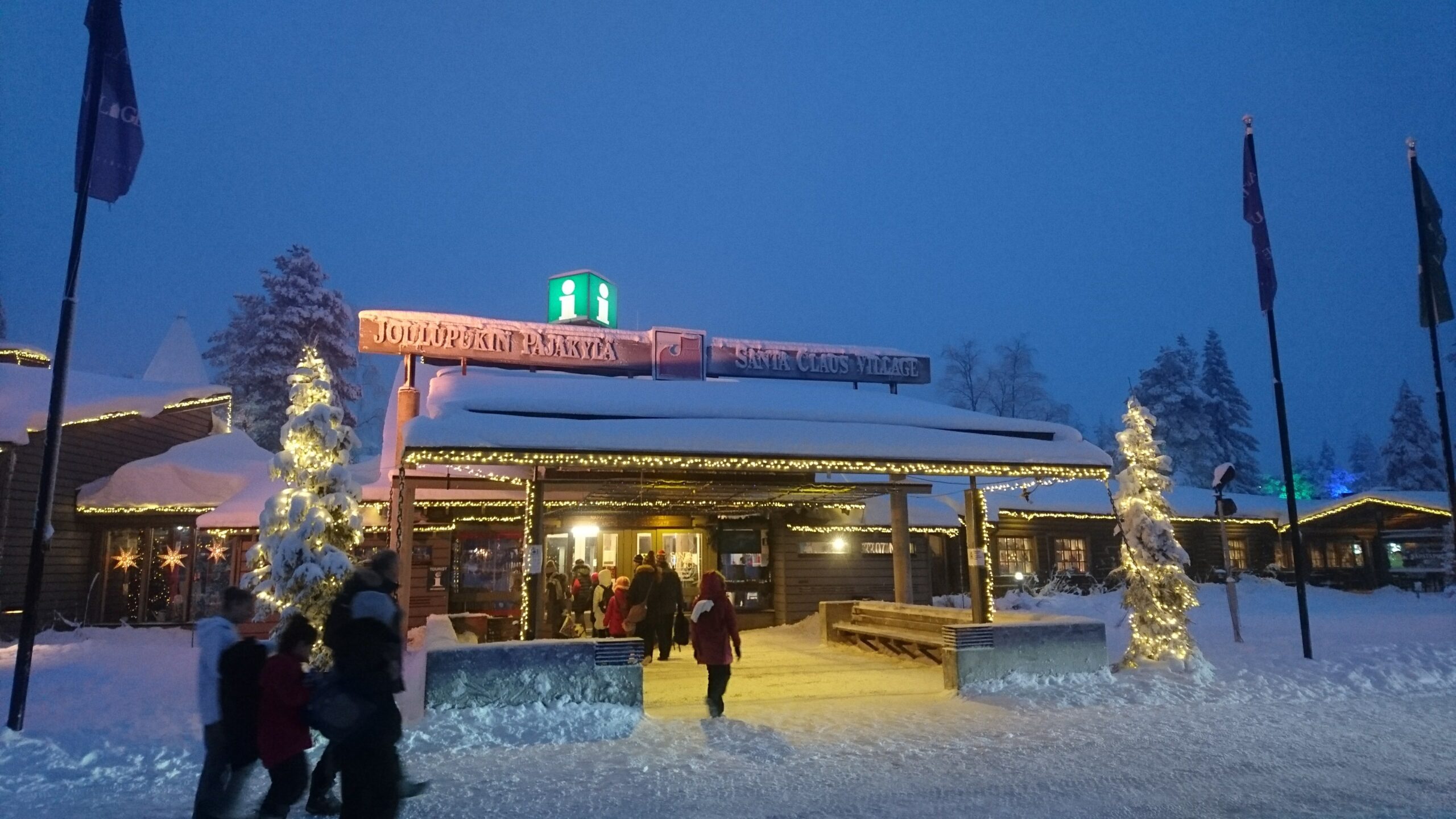 雪の中に明かりが灯るサンタクロース村の入口