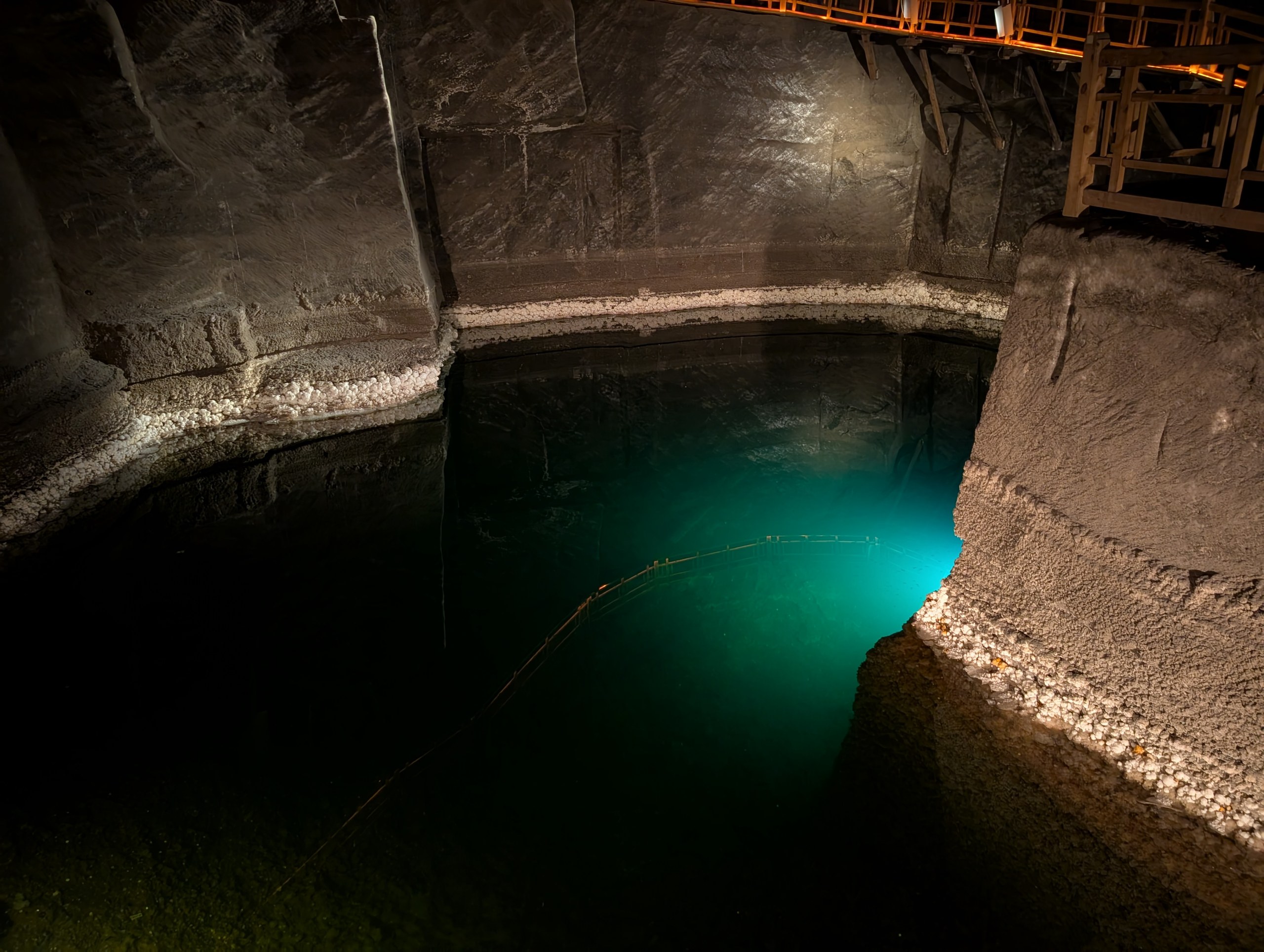 青緑に光る、岩塩坑の中の地底湖
